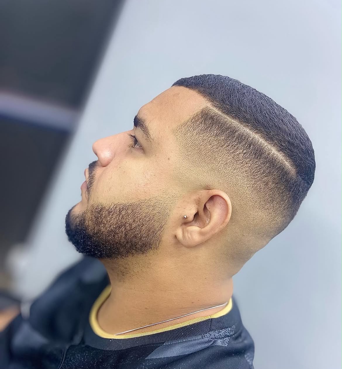 Degradê com risco lateral e barba alinhada